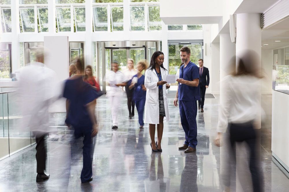 2 people standing looking at a piece of paper