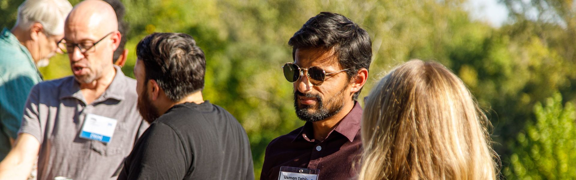 group of people chat on outdoor deck during networking event